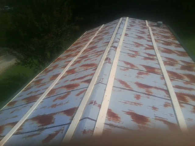 Rusted metal roof panels with new wood purlins before replacement — Storm Damage Roof Repair in Santa Ysabel by Roofing Brothers
