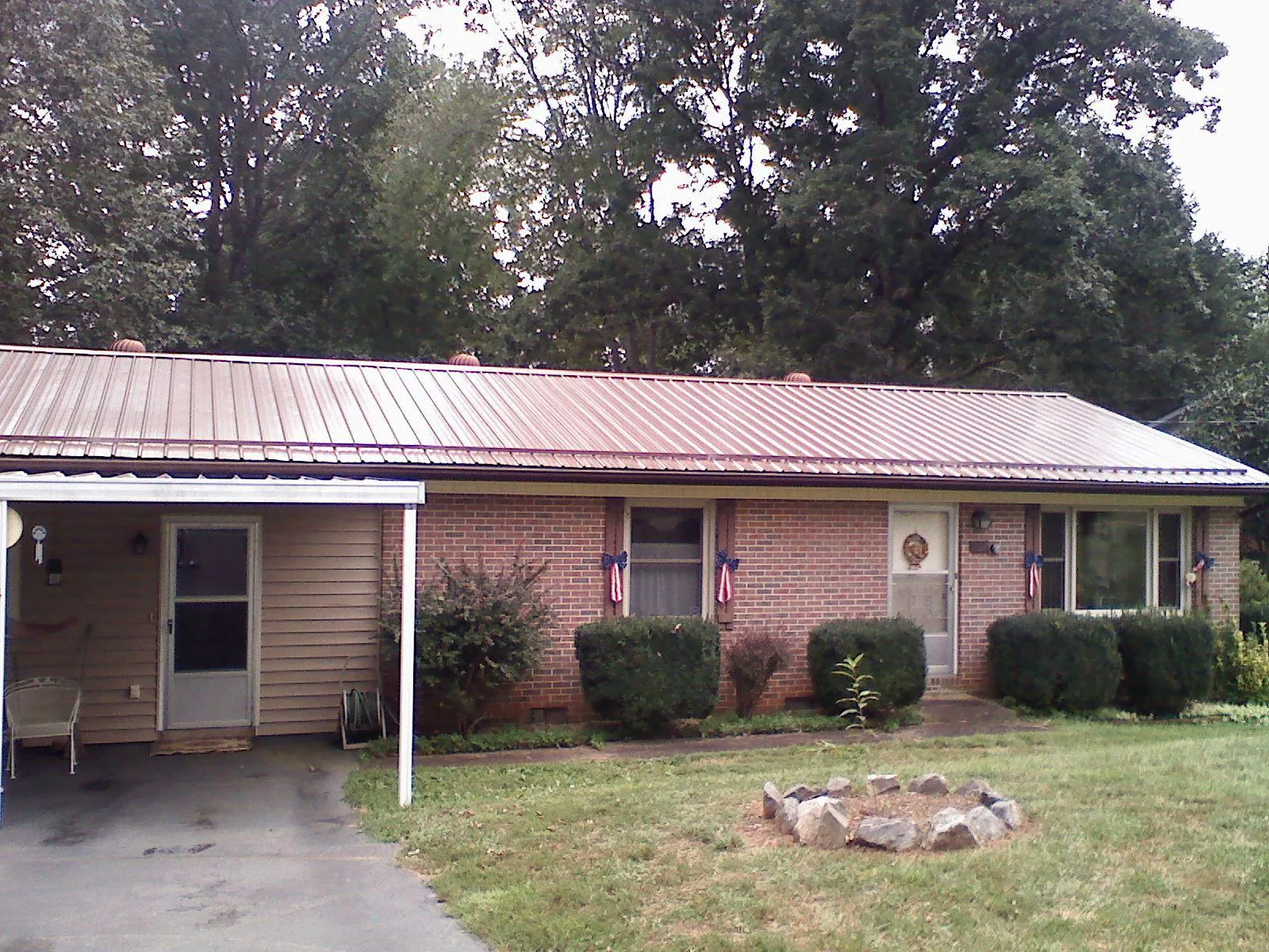 Bronze metal roof and carport on a brick ranch home — Roof Repair work by our crew in Santa Ysabel
